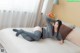 A woman laying on top of a bed in a bedroom.