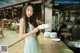 A woman holding a plate of food in a restaurant.