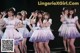 A group of young women standing on top of a stage.