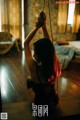 A woman sitting on a swing in a room.