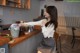 A woman sitting at a counter in a coffee shop.