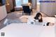 A woman laying on a bed in a hotel room.