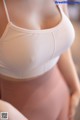 A close up of a woman wearing a white bra.