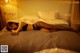 A woman laying on a bed in a hotel room.