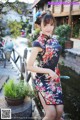 A woman in a black and red dress posing for a picture.