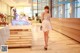 A woman in a short dress standing in front of a counter.