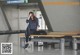 A woman sitting on a bench in an airport.