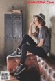 A woman sitting on top of a brown couch.