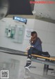 A woman sitting on a bench in an airport.