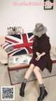 a woman sitting on top of a table next to a british flag