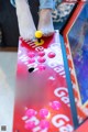 A person playing a game of pinball on a table.