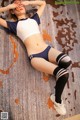 A woman laying on the floor in a blue and white outfit.