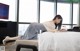 A woman laying on a bed reading a book.