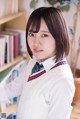 A woman in a school uniform posing for a picture.