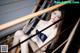 A woman in a blue lingerie sitting on a wooden staircase.