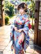 A woman in a blue kimono posing for a picture.